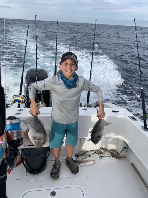 Crockett Sportfishing Gallery Kid with Two Fish